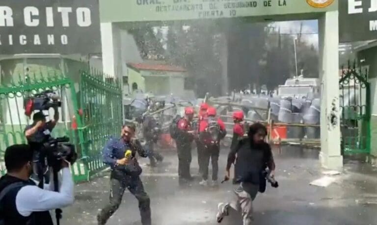 Policía militar lanza chorros de agua contra manifestantes y periodistas durante protesta por caso Ayotzinapa