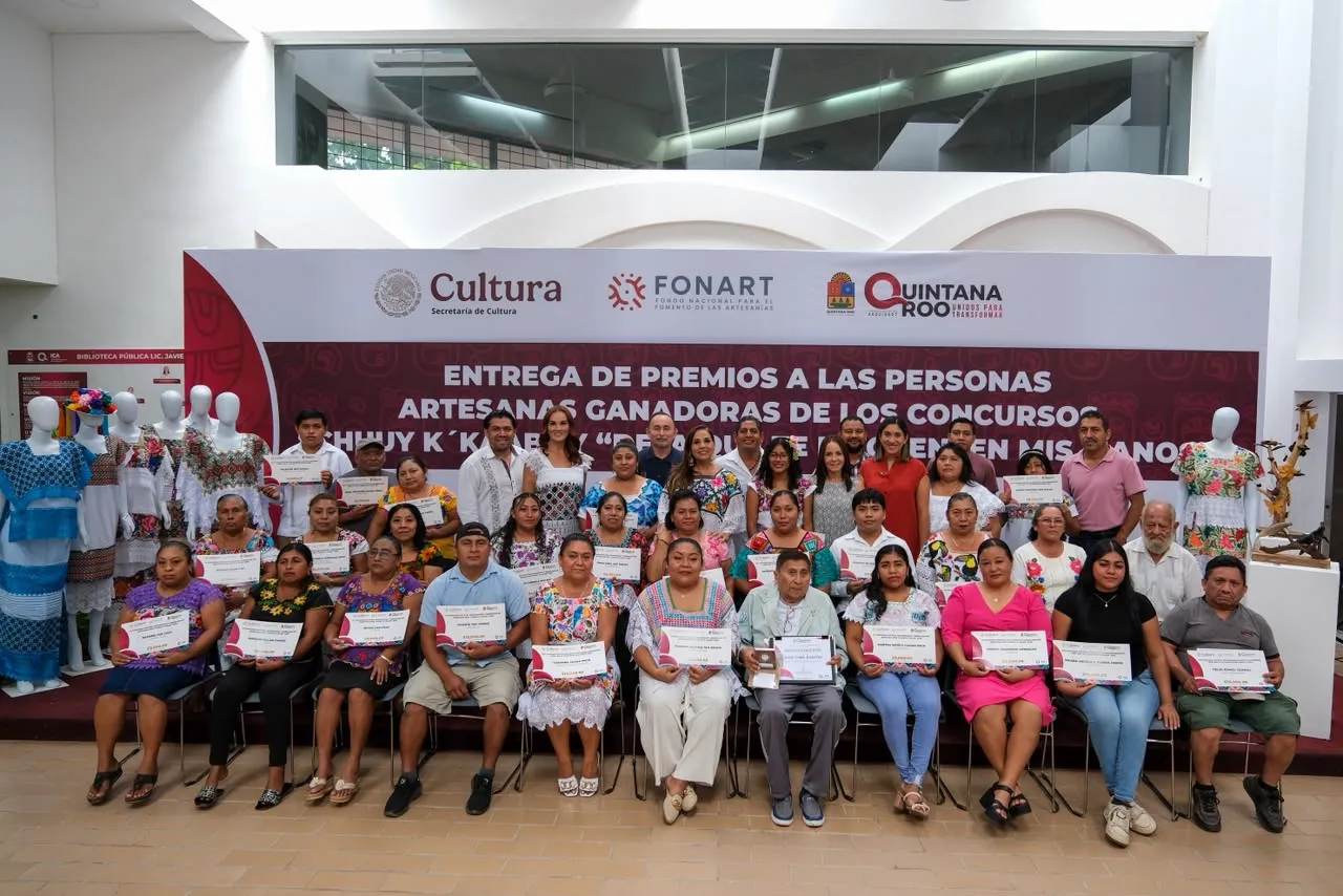 Artesanas y artesanos premiados posan con sus reconocimientos en la Biblioteca Pública Central de Chetumal